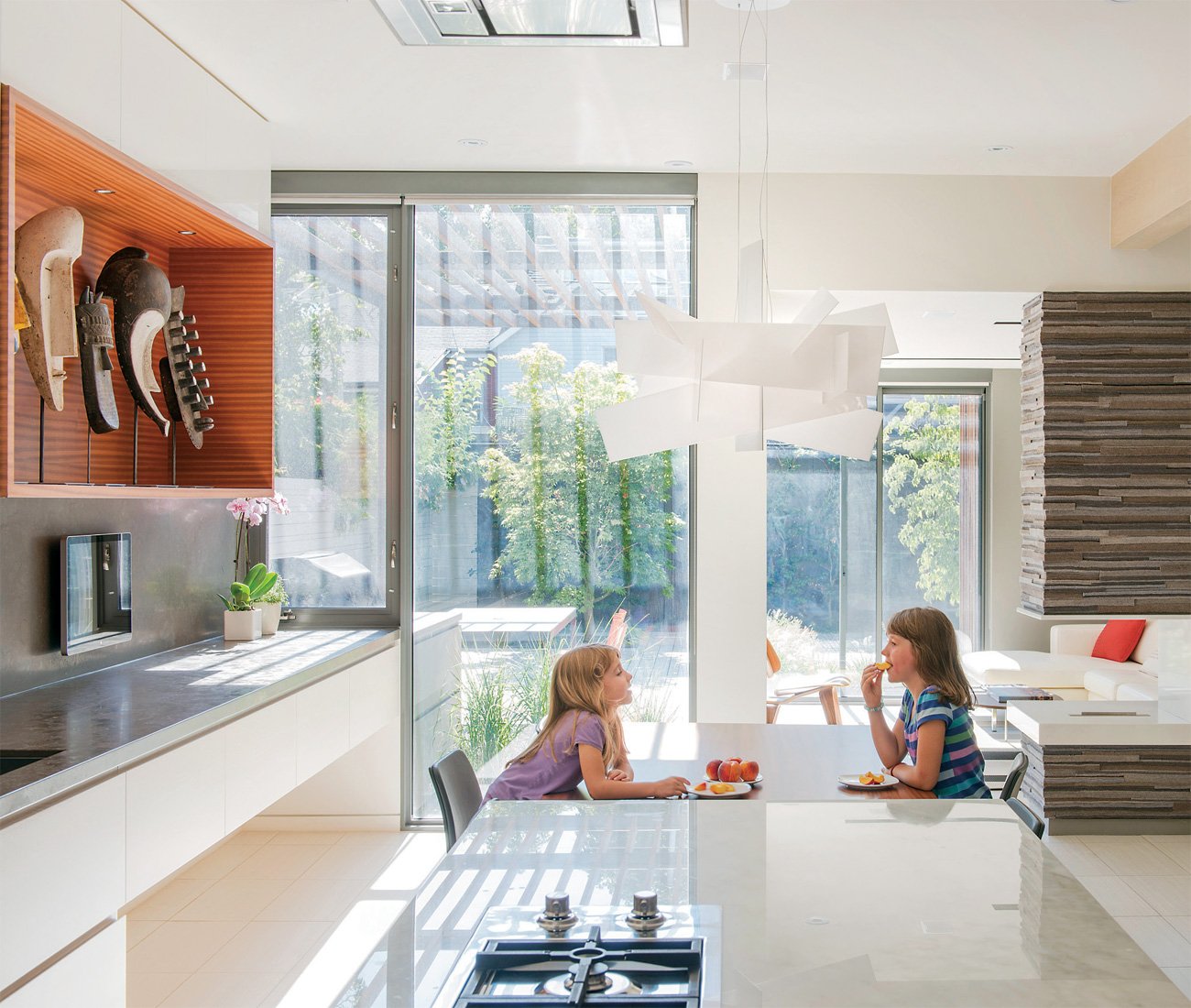 Through House - two kids are eating fruit in the kitchen