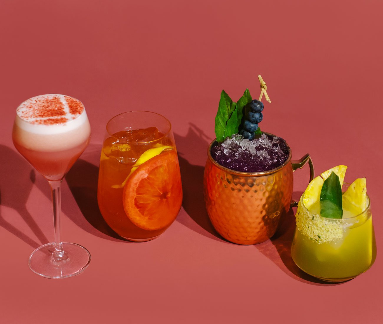 colourful cocktails on different glasses