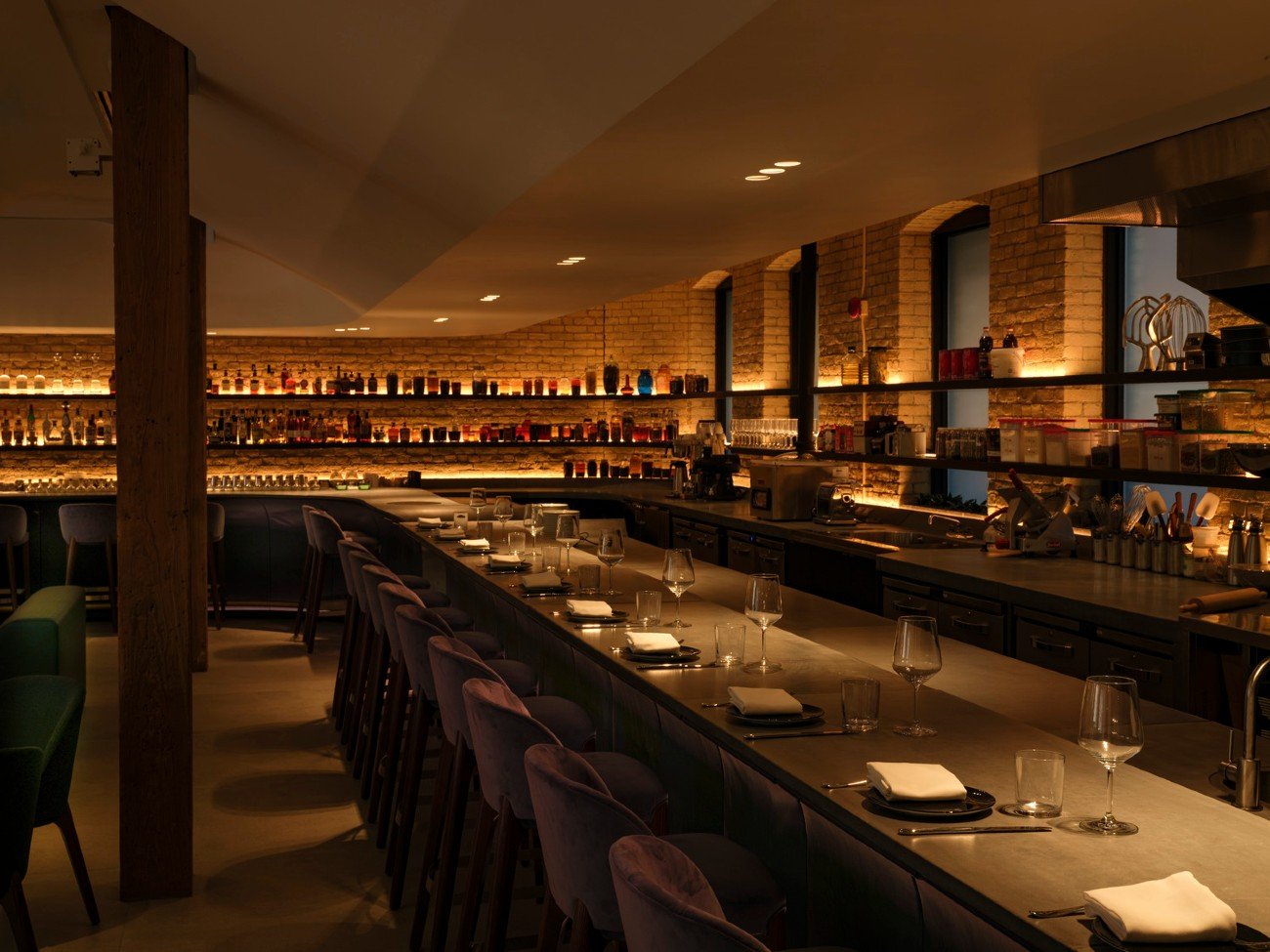 Soft lights on the bar counter at Vela Restaurant in Toronto by Partisans