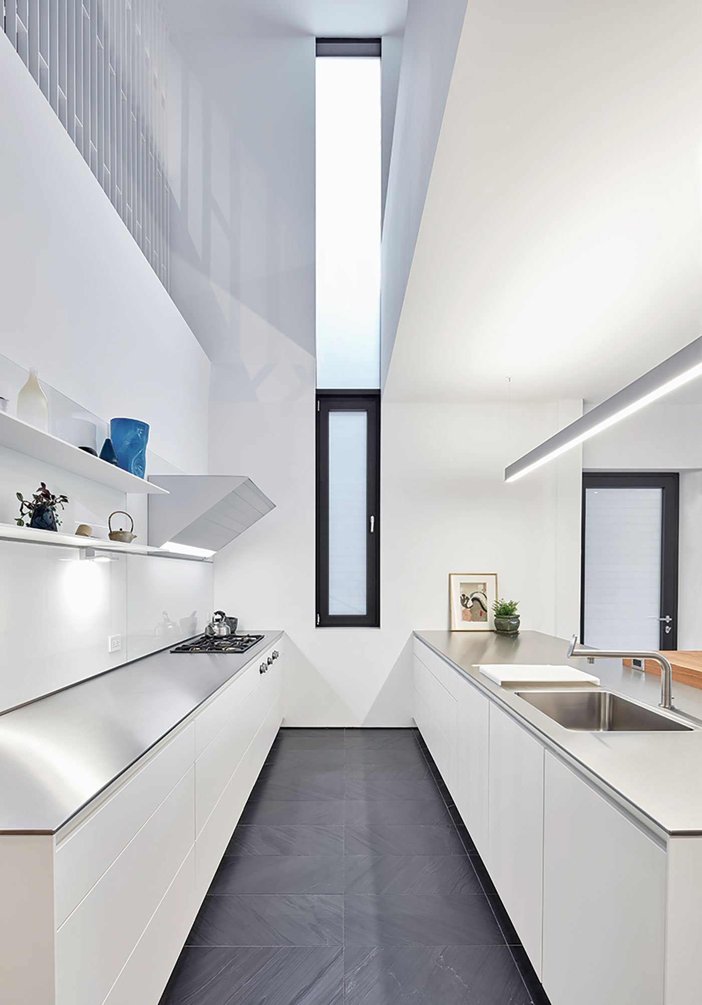 Kitchen with white cabinets Tile House by Kohn Shnier Architects